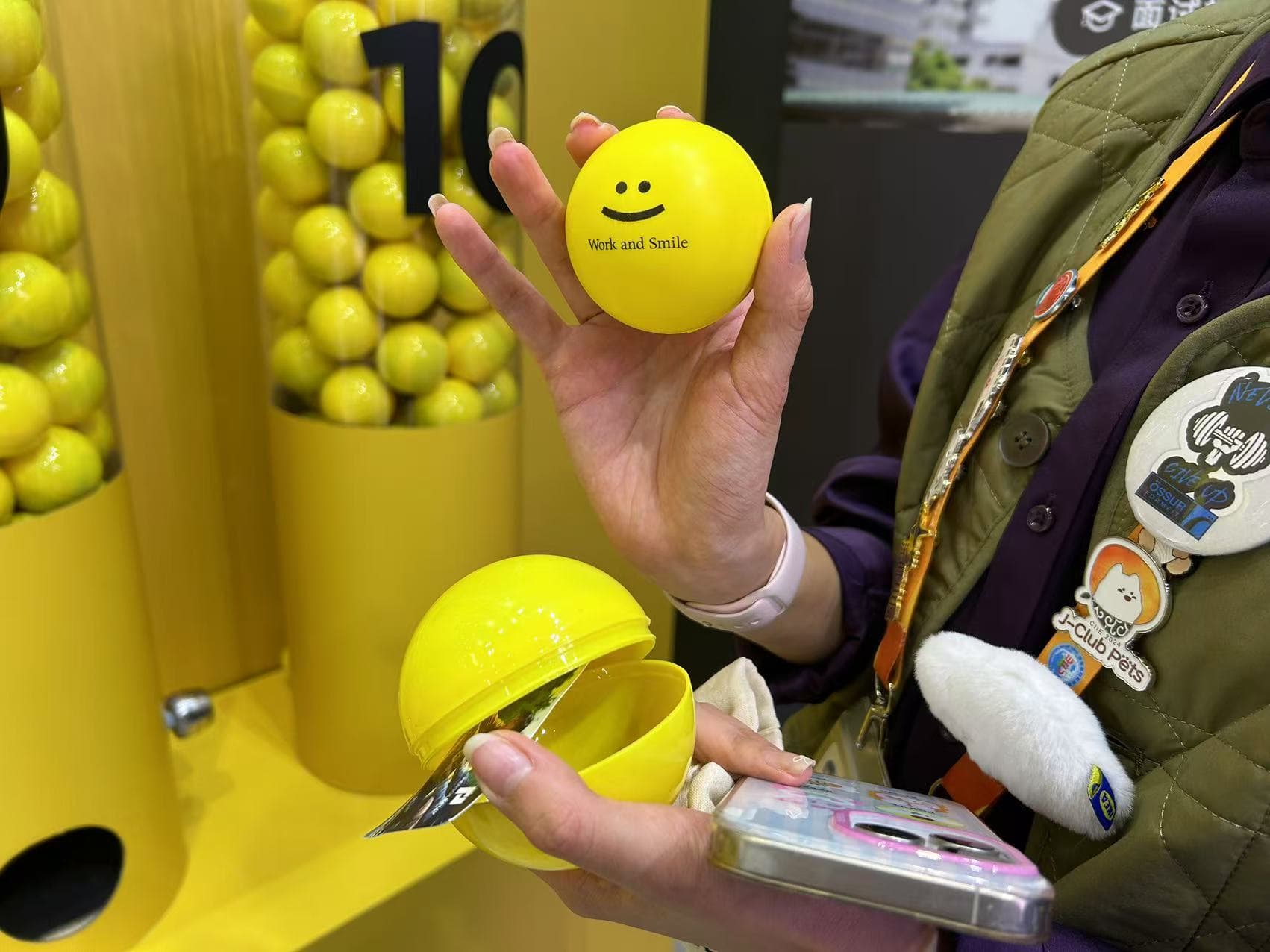 Visitor holding an open yellow Work and Smile capsule