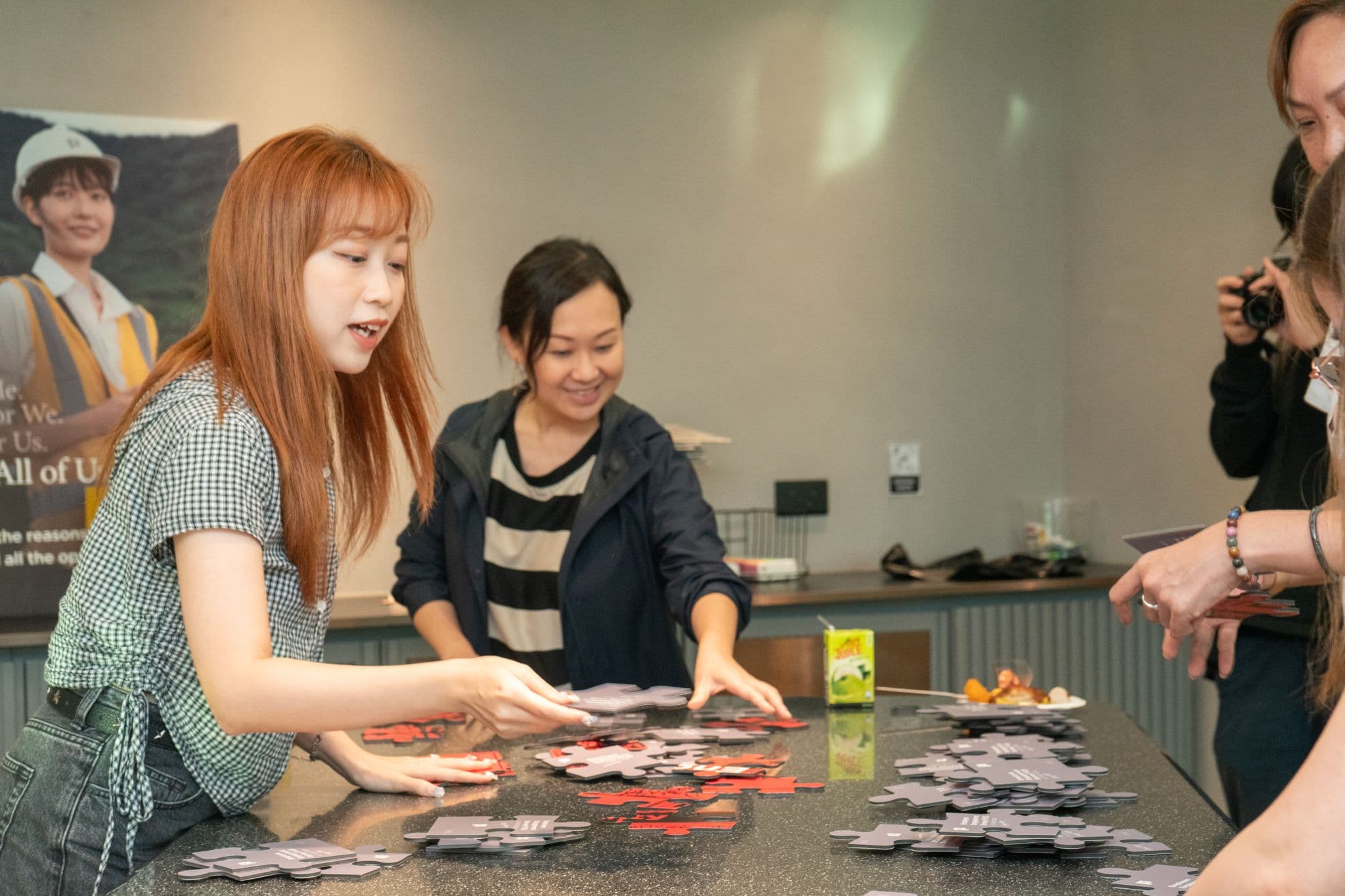 Colleagues assembling the employee survey puzzle together