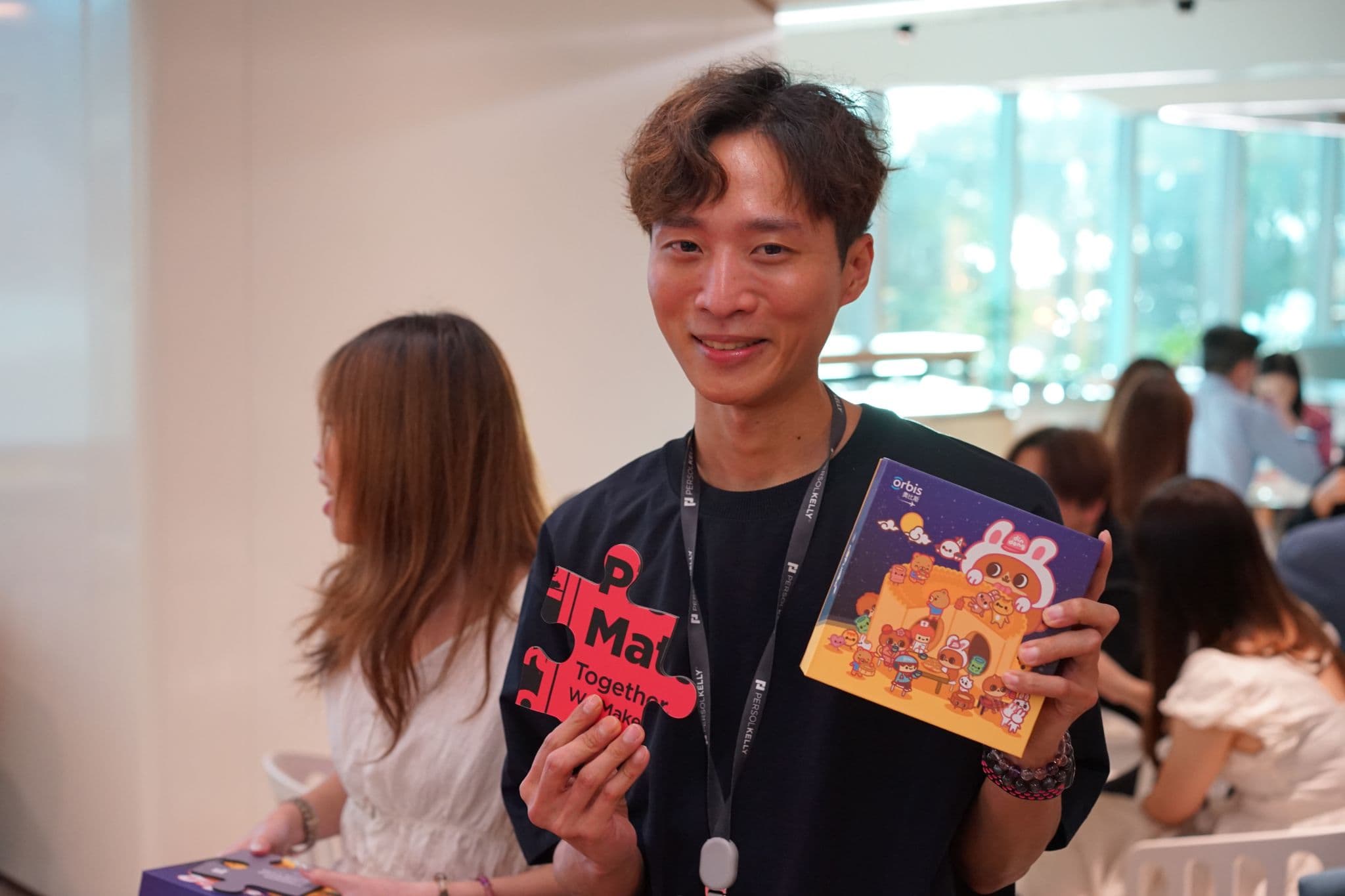 Employee holding a puzzle piece and Mid-Autumn gift